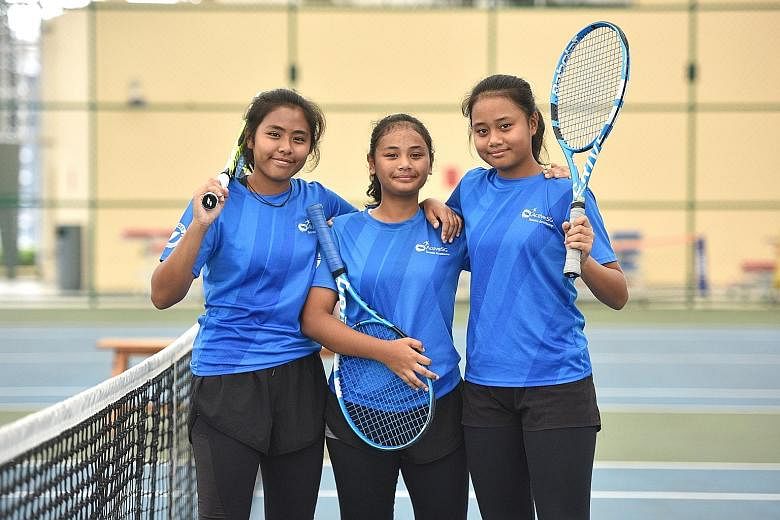 The ActiveSG Tennis Academy at the Heartbeat@Bedok is a family affair for sisters (from left) Haseenah Mohamad Tahar, 16, Hadhinah, 15, and Hanisah, 13. They were previously coached by their father Tahar, who now works at the academy. ST PHOTO: KELLY