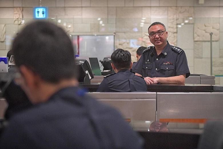 Superintendent Toh Lai Keng, Deputy Commander (Ground Operations), Airport Command, with a screening officer at the checkpoint for arrivals at Changi Airport's Terminal 3. ST PHOTO: ARIFFIN JAMAR