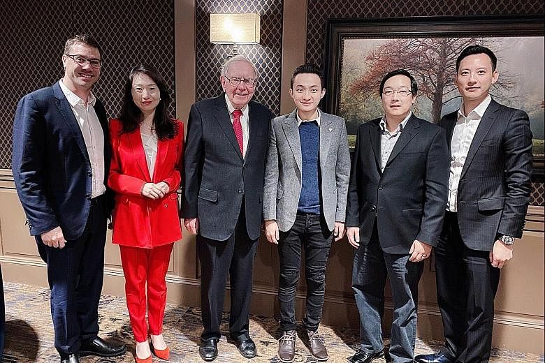 Mr Justin Sun (centre, in light grey jacket) sat down for a $6 million auctioned charity meal with investment guru Warren Buffett, along with guests (from left) Yoni Assia, Helen Hai, Charlie Lee and Chris Lee
