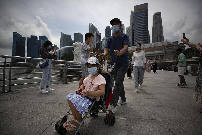Tourists wearing face masks at Merlion Park. The financial impact on economies and companies from the coronavirus outbreak is expected to be worse than the 2003 severe acute respiratory syndrome epidemic. This is due in part to China's role in the gl