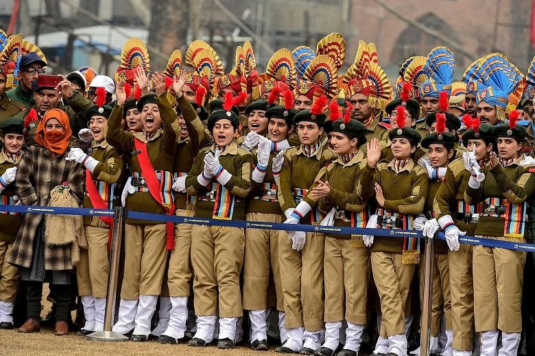 National Cadet Corps personnel watching India's Republic Day parade at a cricket stadium in Srinagar, Jammu and Kashmir, on Jan 26. Huge crowds gathered for the parade, with women taking centre stage. The Indian government last year allowed Permanent