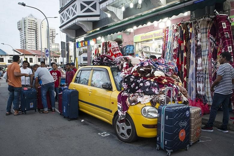 This car in Roberts Lane is filled to the brim with blankets, imported from China and Korea, for sale. It is one of four belonging to Shabnam Trading, which sells blankets and household appliances, mainly to migrant workers, from the cars. Shop owner