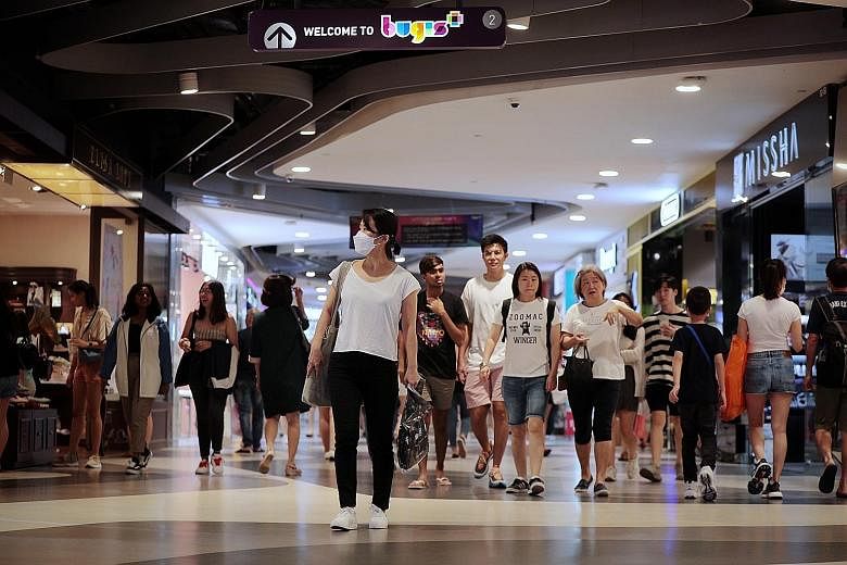 Consumers at Bugis+ shopping mall on Saturday. The coronavirus outbreak could spur more retailers to go online as shoppers avoid crowded areas and turn to e-commerce.
