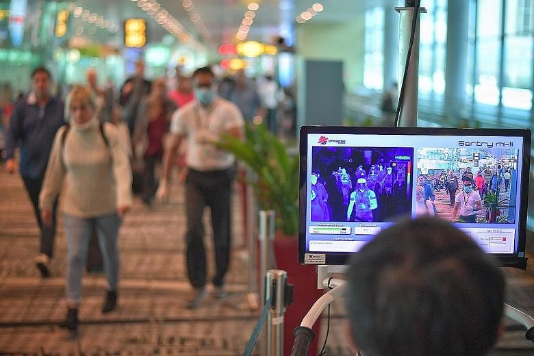 Temperature screening at the arrival area of Changi Airport Terminal 3. The new stay-home notice was prompted by the surge in the number of cases in China outside of Hubei. ST PHOTO: ARIFFIN JAMAR