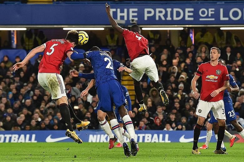 Harry Maguire (left) heading home Manchester United's second goal from a corner during their 2-0 win over Chelsea.