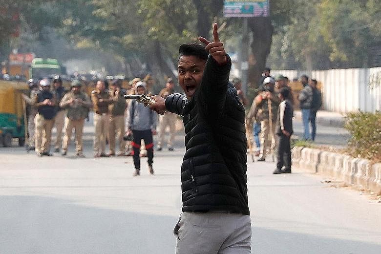 An unidentified teenager brandishing a gun during a protest on Jan 30 against a new citizenship law outside the Jamia Millia Islamia university in New Delhi, India.