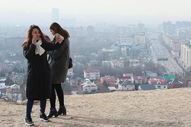Smog covering Almaty on Feb 10. Almaty and Bishkek are two of the largest cities in Central Asia. Both lie in plains surrounded by mountains. The onset of winter has prompted a surge in pollution as people burn coal and other dirty fuels in stoves to