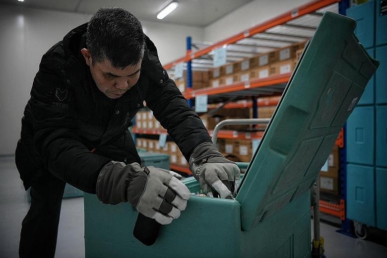 Mr Kenneth Lee packing cartons of medical products into special boxes for cold chain delivery. The former senior production technician went for a professional conversion programme when he was hired as an assistant manager at ST Logistics. ST PHOTO: M