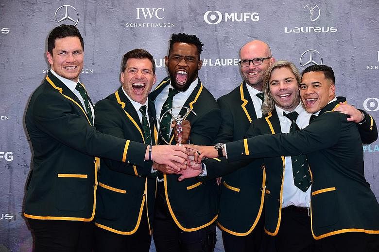Springboks captain Siya Kolisi (third from left) and other teammates represented their Rugby World Cup-winning team in receiving the team of the year award in Berlin. Below: Like the South African rugby team, Lewis Hamilton too had to share his sport
