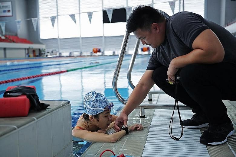 Left: Yip Pin Xiu training with coach Mark Chay at the OCBC Aquatic Centre last week. Above: Mick Massey will work with Yip and Chay in his new role as the Singapore Disability Sports Council's performance director.