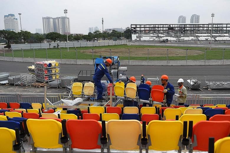 Workers fixing the chairs for the grandstand at the Formula One racetrack in Hanoi. The inaugural Vietnam Grand Prix is set for April 5.