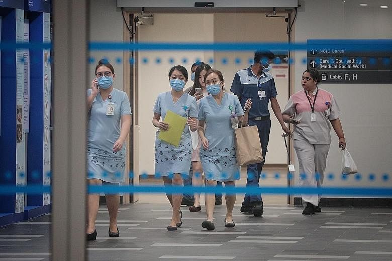 Staff at the National Centre for Infectious Diseases last week. Travel restrictions and the spread of the virus in Singapore and the region have hit the tourism and transport sectors hard, with businesses reporting a drop in sales of up to 50 per cen