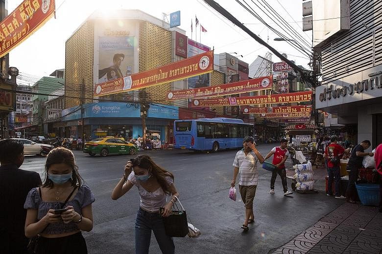 Pedestrians in Bangkok on Feb 5. Thailand's economy is the second-most vulnerable to the coronavirus outbreak, after that of Hong Kong, with its strong reliance on China trade and Chinese tourists, say analysts.