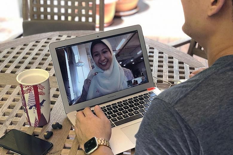 Ms Athirah Khairunnisa (on laptop screen), an account manager at Splash Productions, conducting a video conference call with her colleagues who are based at separate worksites. The marketing communications company split its staff into two teams a wee