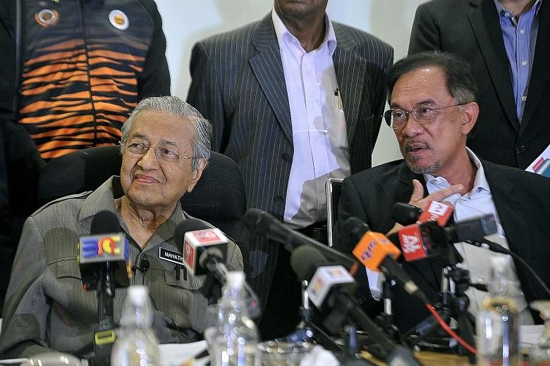 Malaysian Prime Minister Mahathir Mohamad (at left) and Parti Keadilan Rakyat president Anwar Ibrahim at a press conference on Aug 30 last year, after a Pakatan Harapan presidential council meeting. A deal for a mid-term power transition between the 