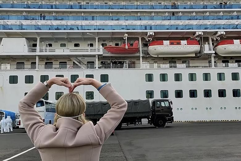 Princess Cruises president Jan Swartz gesturing towards the Diamond Princess liner at the dock in Yokohama, as passengers disembarked yesterday after two weeks of quarantine.