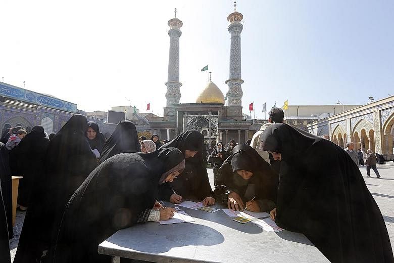 Iranian women at a polling station set up at the Shah Abdul Azim shrine during the parliamentary elections in Teheran yesterday.