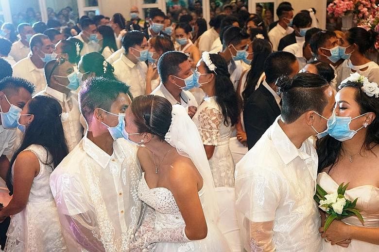 Wearing blue surgical masks amid the coronavirus outbreak, 220 couples exchanged vows and kisses on Thursday in the central Philippines to begin their married lives in the coastal city of Bacolod. Participants had to complete health declarations deta