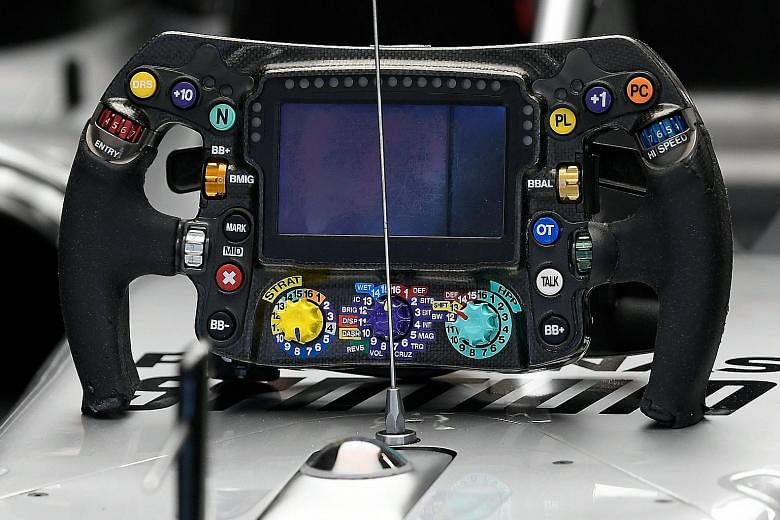 Above: Mercedes' Lewis Hamilton during the official Formula One pre-season testing at the Barcelona-Catalunya circuit on Thursday. Left: Hamilton's steering wheel.