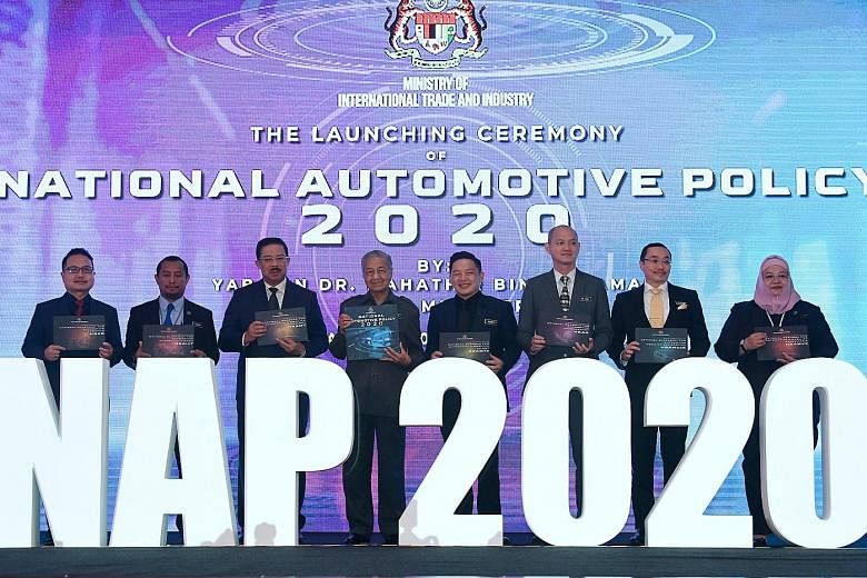 Malaysian Prime Minister Mahathir Mohamad at the launch of the National Automotive Policy 2020 yesterday. Among those present were International Trade and Industry Minister Darell Leiking (fourth from right) and Deputy Minister Ong Kian Ming (third f