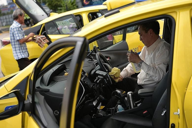 During his daily 10-hour shifts, cabby Harry Ng now makes at least three stops to wipe down his car with disinfectant. He also makes sure to clean every part of his cab that might come into contact with his passengers. ST PHOTO: KUA CHEE SIONG