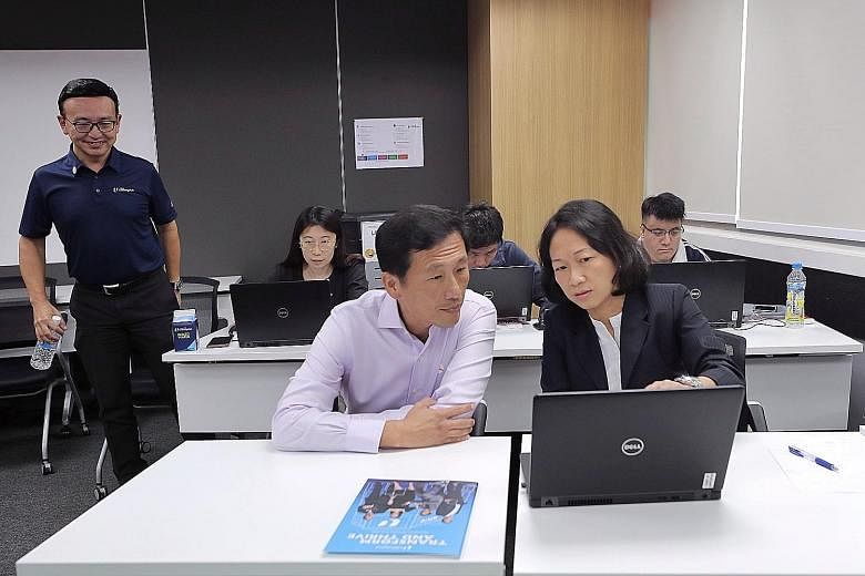 Left: A coding class at the NTUC LearningHub in Bras Basah yesterday. More than 100,000 Singaporeans have attended workshops and talks under SkillsFuture Advice at community centres or clubs, to find out more about skills upgrading. Below: Education 