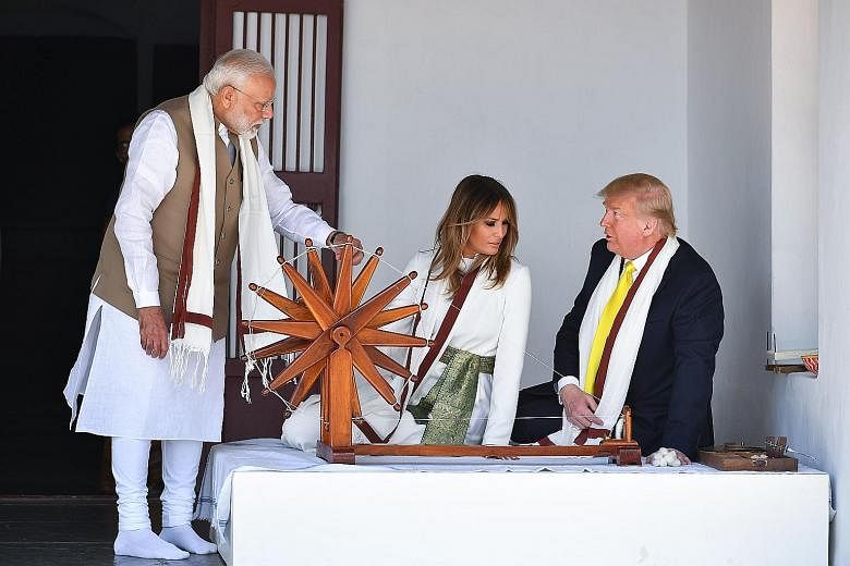 US President Donald Trump and First Lady Melania Trump sitting next to a charkha, or spinning wheel, during their visit to Gandhi Ashram in Ahmedabad yesterday with India's Prime Minister Narendra Modi. The spinning wheel is associated with Mahatma G