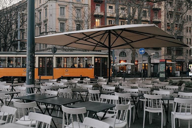 Empty seats outside a bar in Milan on Monday. A spike in coronavirus infections in northern Italy has hit businesses hard. Codogno, Italy's epicentre of infection, is just 60km south of Milan. PHOTO: NYTIMES