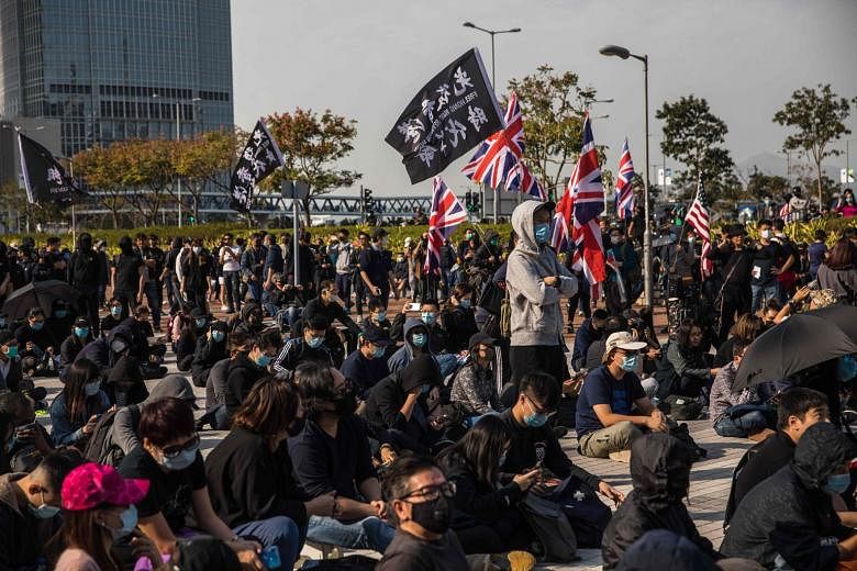 Pro-democracy protesters at a Edinburgh Place rally in the Central district of Hong Kong last month. The coronavirus outbreak comes on top of anti-government protests that drove Hong Kong into recession last year and economists now forecast another s