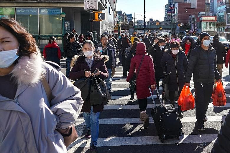 Pedestrians in the Chinatown area of Queens, New York. The US Centres for Disease Control and Prevention is gearing up for the community spread of the coronavirus in the US, warning it is not a matter of if, but when and how many people in the countr