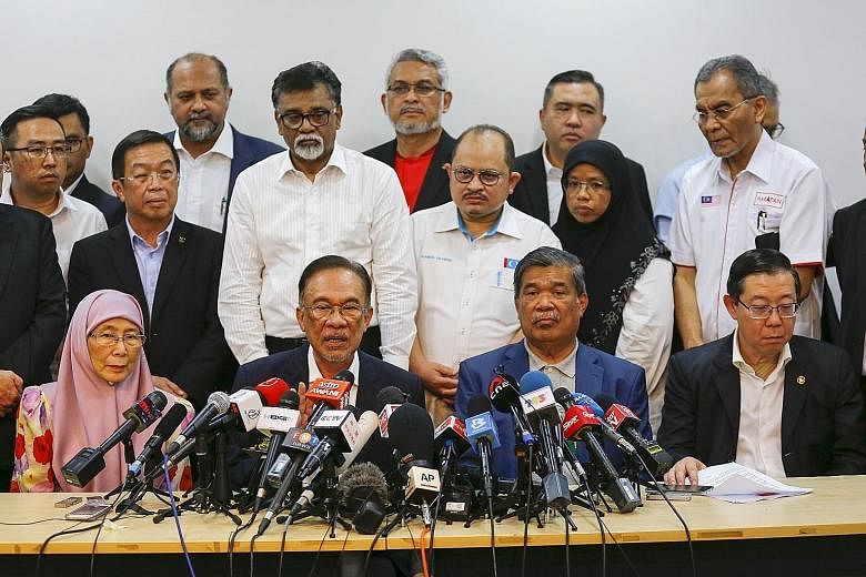 PKR president Anwar Ibrahim at the press conference yesterday with (front row, from left) his wife Wan Azizah Wan Ismail, Parti Amanah Negara president Mat Sabu and Democratic Action Party secretary-general Lim Guan Eng.