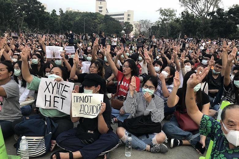 Students at Thammasat University in Pathum Thani province making a three-finger salute at their anti-government gathering on Wednesday.