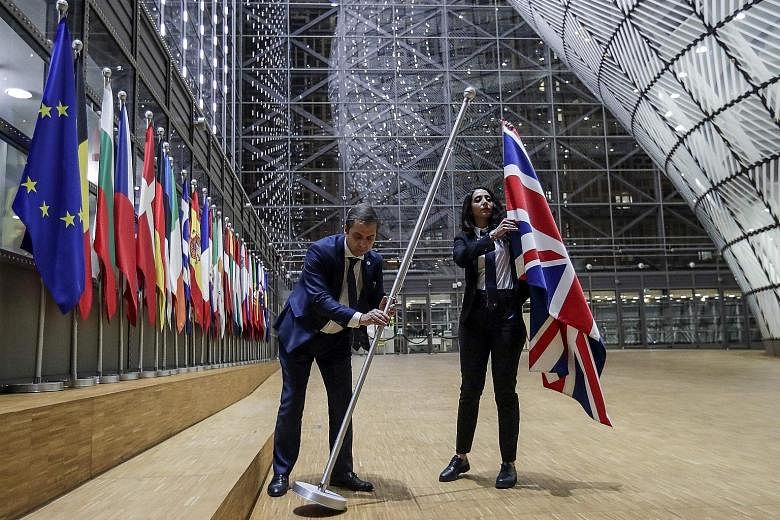 EU Council staff members removing the United Kingdom flag from the European Council building in Brussels on Jan 31, the day Britain left the EU, ending more than four decades of economic, political and legal integration. The EU and Britain will meet 