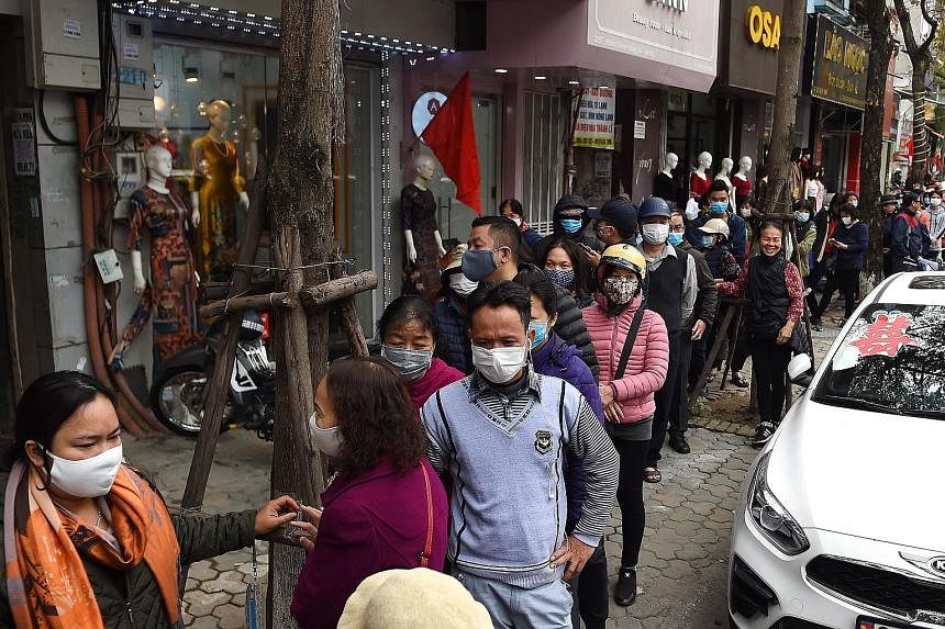 Face masks are flying off the shelves in many countries. There were long queues to buy masks last week in Hanoi, Vietnam (above, left), and people scrambled to buy them in the Philippines (above, right) after the government confirmed the country's fi