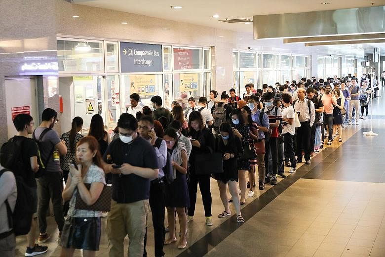 Commuters queueing (top and above) for the bridging bus service at Sengkang Bus Interchange. They took the free service to Buangkok MRT station to continue their journey on the North East Line. ST PHOTOS: ONG WEE JIN