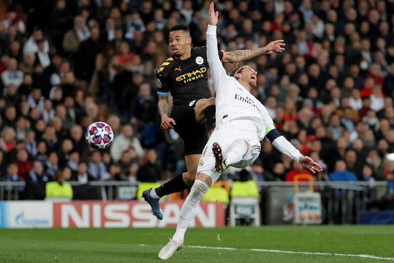 Manchester City's Gabriel Jesus battling with Sergio Ramos to score during the 2-1 Champions League last-16, first-leg win over Real Madrid on Wednesday. The Real captain was later sent off for hauling down Jesus. PHOTO: REUTERS