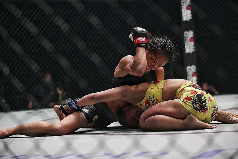 Singapore's Tiffany Teo elbowing Japan's Ayaka Miura during their strawweight bout in One Championship's King of the Jungle event at the Singapore Indoor Stadium last night. ST PHOTO: KEVIN LIM