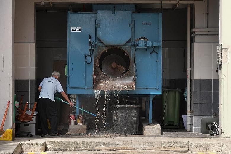 An elderly cleaner washing a rubbish collection area in Toa Payoh. Deputy Prime Minister Heng Swee Keat said the Budget provides further support for those who may face greater pressures, such as with income and employment, but asks businesses to play