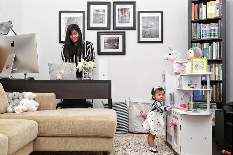 Senior compliance consultant Nasuha Marican works out of a room that also doubles as a play area for her 11-month-old daughter, Noura. 