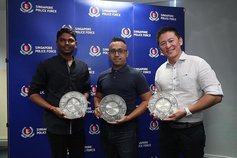 (From far left) Security officer Logaisraja Nadurajah, Certis auxiliary police officer Hidayat Hassan and Grab liaison officer Desmond Ng with their Public Spiritedness awards at Jurong Police Division last week.