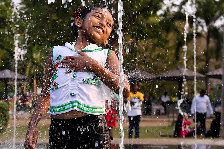 A Sri Lankan girl playing at a water fountain on a hot day at a public park in Colomboon Saturday. The Department of Meteorology in Sri Lanka on Friday issued a hot weather advisory to 11 districts, including the North-Western, Western, Southern and 