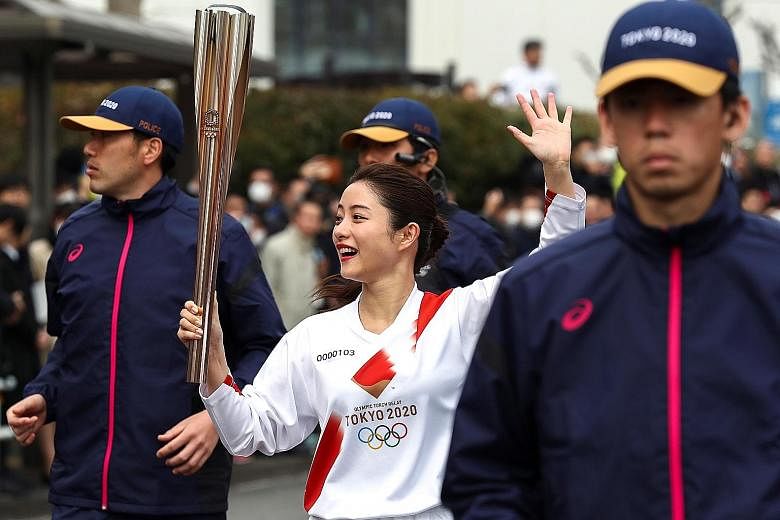 Japanese actress Satomi Ishihara, an official ambassador for the Games runs with the Olympic torch during a rehearsal in Tokyo. Japan is pulling out all the stops to make sure her rehearsal will not prove futile. PHOTO: REUTERS