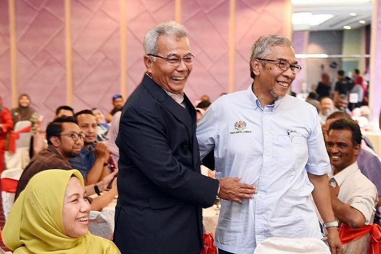 Former entrepreneur development minister Redzuan Yusof (left) and his former deputy minister Hatta Ramli at a ministry function last Thursday that was also attended by a confirmed coronavirus patient.
