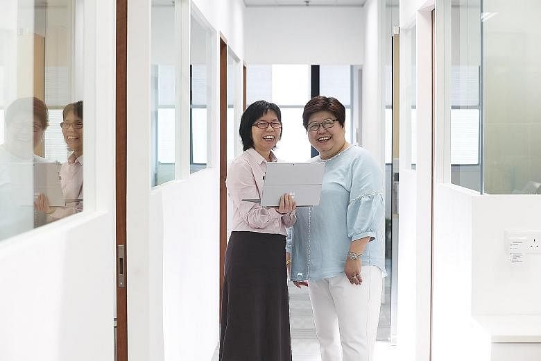 Ms Janna Chui with her boss Emerlin Toh (far right). After Ms Chui underwent the professional conversion programme for Microsoft SQL server administrator or developer, Ms Toh, managing director of Reach Technologies, felt she had held her own and pro