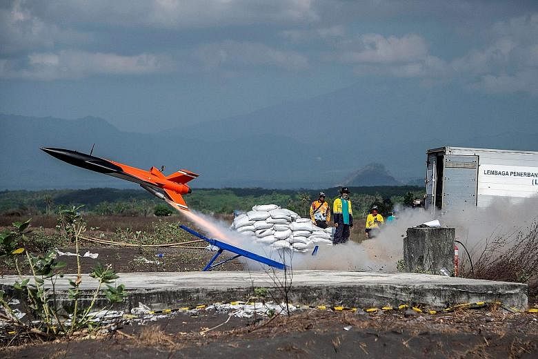 A photo snapped on Nov 19 last year showing a miniature test rocket taking off as Indonesia's little-known space agency, the National Institute of Aeronautics and Space, tested equipment on barren scrub land in Lumajang, East Java. PHOTO: AGENCE FRAN
