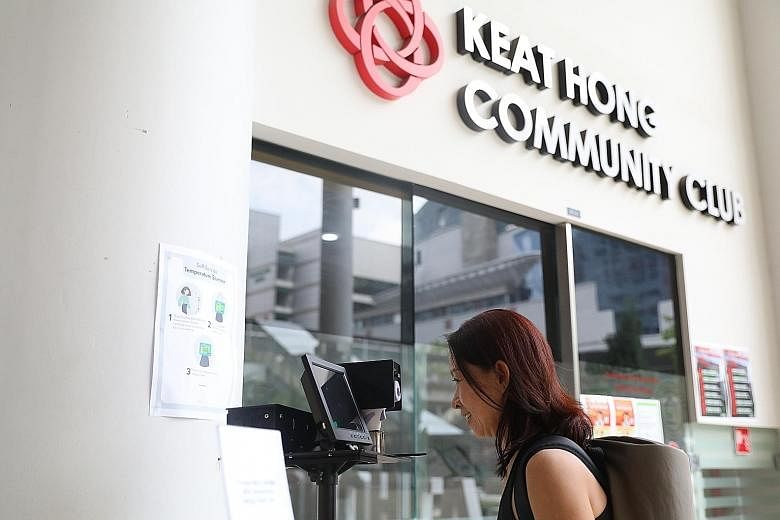 Yoga trainer Jeannie Tai, 54, having her temperature checked with the automated scanner at Keat Hong Community Club. The scanning system requires no human contact or intervention and has been deployed in more than 30 government and community building