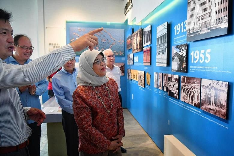 Singapore Hokkien Huay Kuan (SHHK) vice-president Chan Hock Keng giving President Halimah Yacob a tour of the clan association's gallery yesterday. Madam Halimah spoke to about 50 attendees at the SHHK Cultural Academy in Sennett Road as part of her 