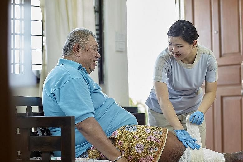A nurse from the Home Nursing Foundation changing a patient's dressing during a house visit. As Singapore moves healthcare beyond hospitals to the community to meet the needs of an ageing population, the Government is doing more to make the sector mo