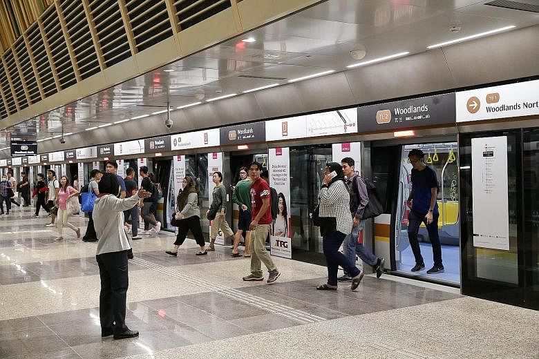 Passengers alighting at Woodlands station of the Thomson-East Coast Line. The $60 billion sum will fund upcoming projects such as the Thomson-East Coast Line, the Jurong Region Line and extensions to the North East Line and Downtown Line, Transport M