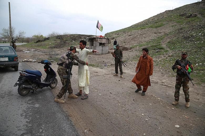 Security officials conducting a body search at a checkpoint in Nangarhar province, Afghanistan, on Wednesday. The International Criminal Court's ruling comes days after the Taleban killed at least 20 Afghan soldiers and policemen in overnight attacks